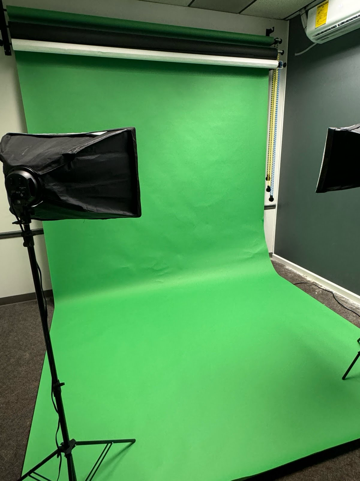 Green screen media studio at PAD 2 with lighting, camera setup, and production equipment for photo and video shoots