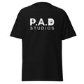 Black PAD Studios t-shirt featuring white studio logo with microphone and media icons